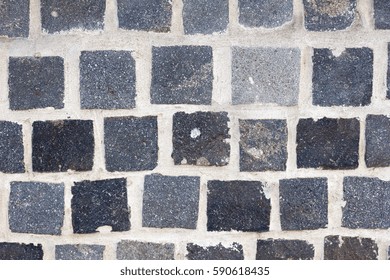 Wall of gray stone bricks
