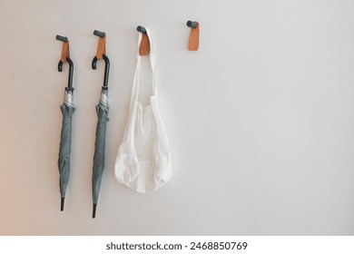 Wall Hanging, Cloth bags and umbrellas hung on the walls of the room. Copyspace. - Powered by Shutterstock