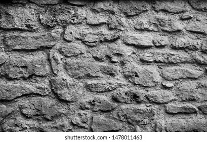 Wall Of High Quality Travertine Or Thermolith. Background In Aligned Stone Wall Clear And Black. Texture For Backgrounds Or Wallpaper. Black And White Photography. 