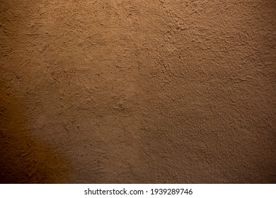 wall of home made from mud or adobe house. Clay wall texture of House structure. Soil building for background and dark tone. soft picture. Selective focus