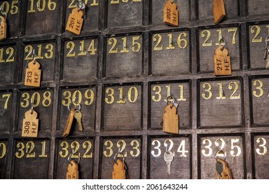 Wall At Hotel Reception With Numbered Keys Hanging On Hooks