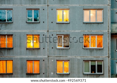 Wall with iIluminated windows. Detail of soviet era block apartment building