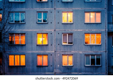 Wall with Iluminated windows. Detail of soviet era block apartment building