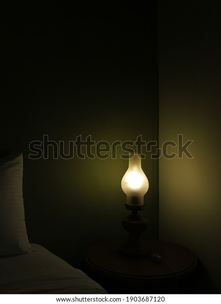 wall lamp at the head of the bedroom\
bed,bed side lamp and modern styled switches can be seen,Hotel bed\
accessories with the night lamp at the head\
board.
