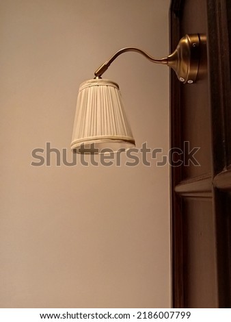 A wall lamp in a modern hotel in the heart of Surabaya, East Java, Indonesia on August 3rd, 2022.
