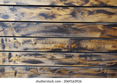 Wall made of burnt and brushed wooden planks