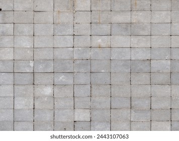 Wall made of rectangular cinder blocks with stack bond checkered pattern. Full-frame flat background and texture.
