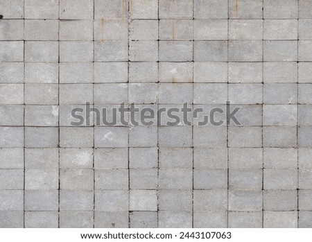 Wall made of rectangular cinder blocks with stack bond checkered pattern. Full-frame flat background and texture.