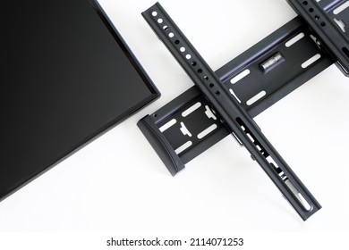 Wall Metal Bracket For Installing A TV Or Monitor On A White Background. The Concept Of Mounting A Modern TV Or Computer Monitor On The Wall. Close-up