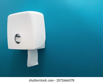 Wall Mounted Bathroom Tissue Dispenser On Blue Wall