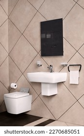 wall mounted closet and tissue holder. Matt effect large wall tiles. Wall-hung disabled washbasin open sinks in bathroom.