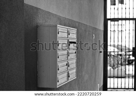 Wall mounted letterboxes or post boxes for flats. Black and white photo