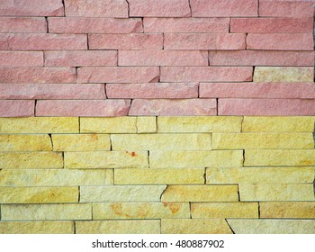 The wall of multi-colored facing stone close up