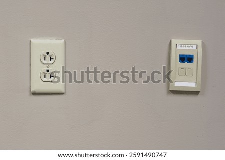 Wall with network jack on right and electric outlet on left