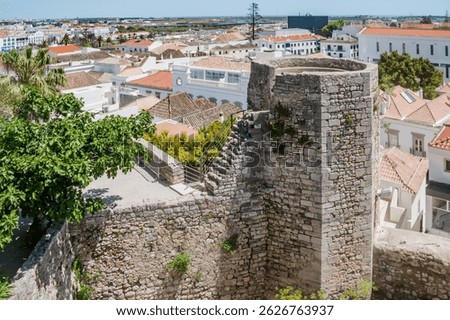 Wall and octagonal albarrã tower of the castle and architecture of Tavira, PORTUGAL