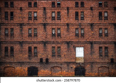 Wall Of The Old Factory Building Of Red Brick With Narrow Windows