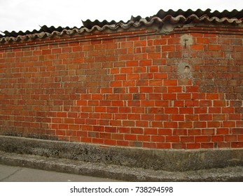 Wall of old red clay bricks