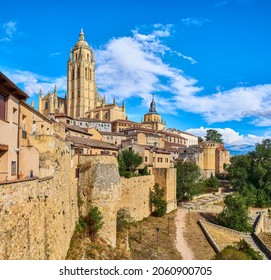 The wall of the old town of Segovia, with the Bell tower of the Cathedral in the background. View from Segovia Museum viewpoint, Calle del Socorro street. Segovia, Spain.