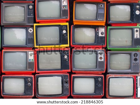 A wall of old vintage tube televisions