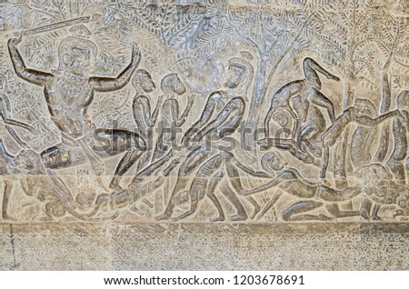 The wall of one of the galleries of Angkor Wat with its linear arrangement of stone carving, adorned with bas-reliefs mainly depicting episodes from the Hindu epics the Ramayana and the Mahabharata 

