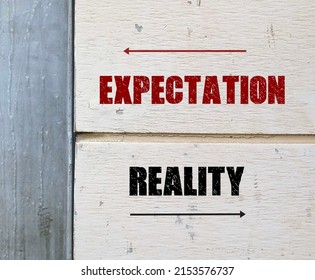 Wall with opposite direction sign written EXPECTATION and REALITY,  means difference between what was expected and what happened which drives positive and negative human emotions