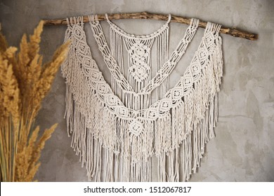 Wall panel in the style of Boho made of cotton threads in natural color using the macrame technique for home decor and wedding decoration. Beautiful boho macrame wall panel will add a cozy atmosphere 