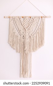 Wall panel in style of Boho made of cotton threads using the macrame technique for home decor and wedding decoration. Cozy Home decor concept. White Macrame in living room with boho interior design