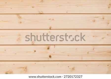 A wall panel of warm, light pine wood planks with natural grain and knots. Ideal as a neutral backdrop for product shoots, design concepts, or rustic visuals and branding