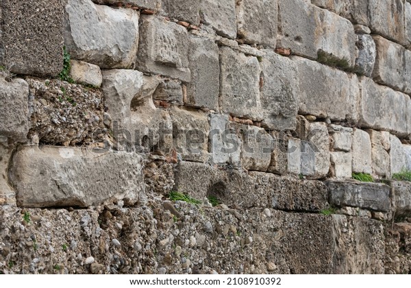 The wall is paved with gray stones, top view.\
stone texture, outdoor stone\
tiles