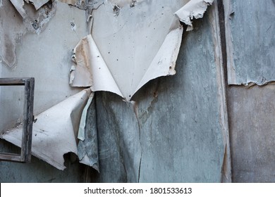 A Wall With Peeling Wallpaper In An Old Abandoned House