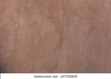 Wall plastered and painted background texture. Exterior building wall facade brown color blank empty, copy space