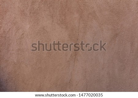 Wall plastered and painted background texture. Exterior building wall facade brown color blank empty, copy space
