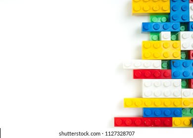 Wall from Plastic building blocks isolated on white background. Top view with copy space