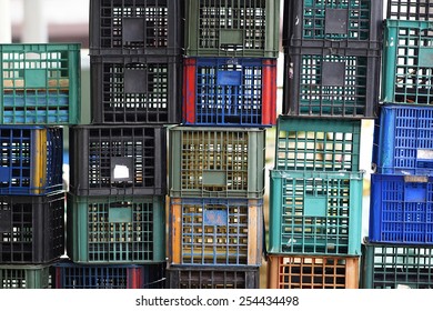 Wall of Plastic Pallets of Various Colors, Aged And Weathered.