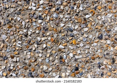 A wall rendered in pebble dash a course plaster surface used on exterior walls