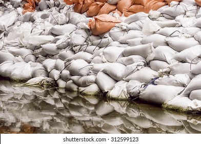 Wall Of Sandbags Reflected By Large Puddle In Parking Lot Near The Illinois River: Documentary Detail For Themes Of Flood Control, Emergency Response, Preparedness