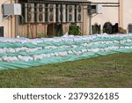 Wall of Sandbags and Tarp for Industrial Building Flood Protection Prevention