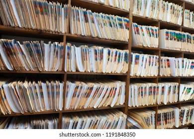 A Wall Of Shelves Containing Patient Records In A Medical Office.