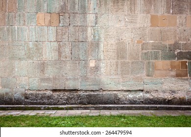 Wall of stone blocks and a pavement