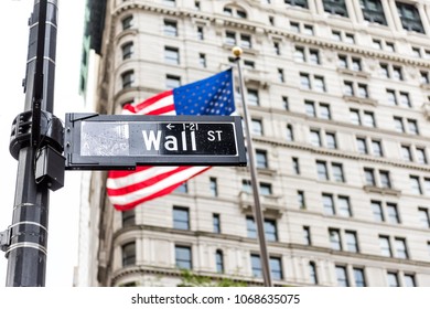 Wall Street Street Sign In New York City NYC Manhattan Lower Financial District Downtown, With American Flag, Banner, Building In Background