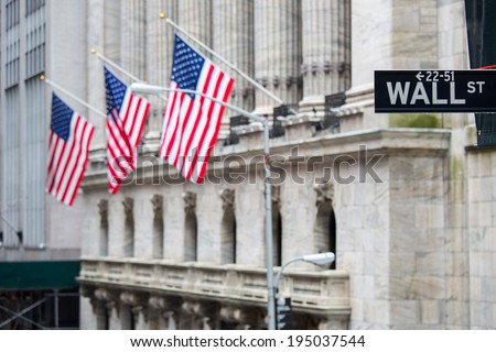 Wall street sign in New York with New York Stock Exchange background