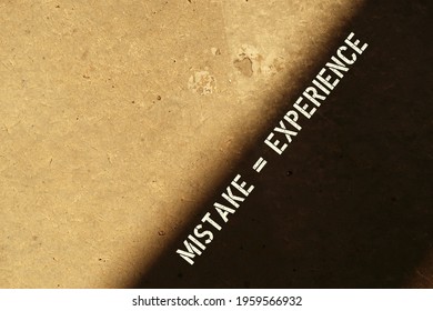 Wall In Sunlight With Contrast Shadow And Text Inscription MISTAKE = EXPERIENCE , Concept Of Daring To Do New Things Out Of Comfort Zone , Turning Mistakes Or Error Into Positive Learning Experiences