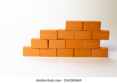 A wall of toy bricks on a white background. - Shutterstock ID 1961583469