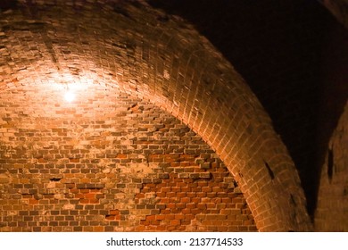 Wall And Vault Of An Old Military Fort, Illuminated By A Lamp. 