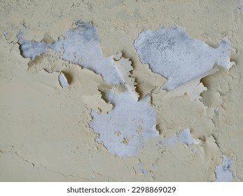 Wall whose paint is partially peeling off stock photo.