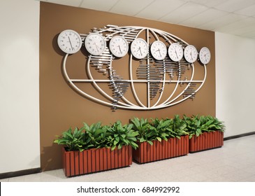 Wall with world map and clocks showing time in different cities