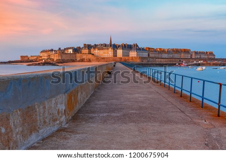 Walled city Saint-Malo with St Vincent Cathedral at sunset. Saint-Maol is famous port city of Privateers is known as city corsaire, Brittany, France