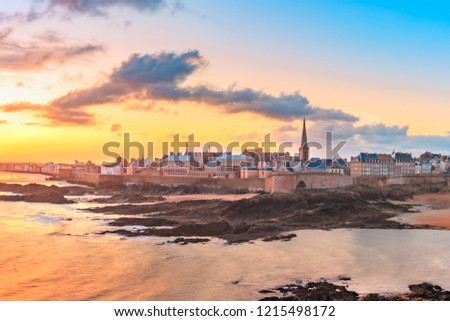 Walled city Saint-Malo with St Vincent Cathedral at sunrise at high tide. Saint-Maol is famous port city of Privateers is known as city corsaire, Brittany, France