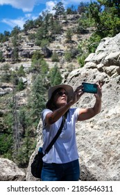 In Wallet Canyon, Arizona, Hopi Tribes Lived And Built Their Dwellings In The Cliffs Looking At A Beautiful Mature Woman Taking Pictures With Her Cell Phone