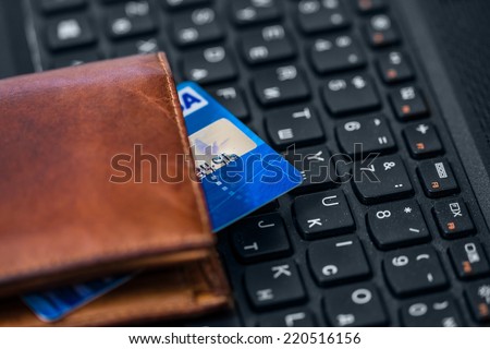 Wallet and card on keyboard. Online banking.